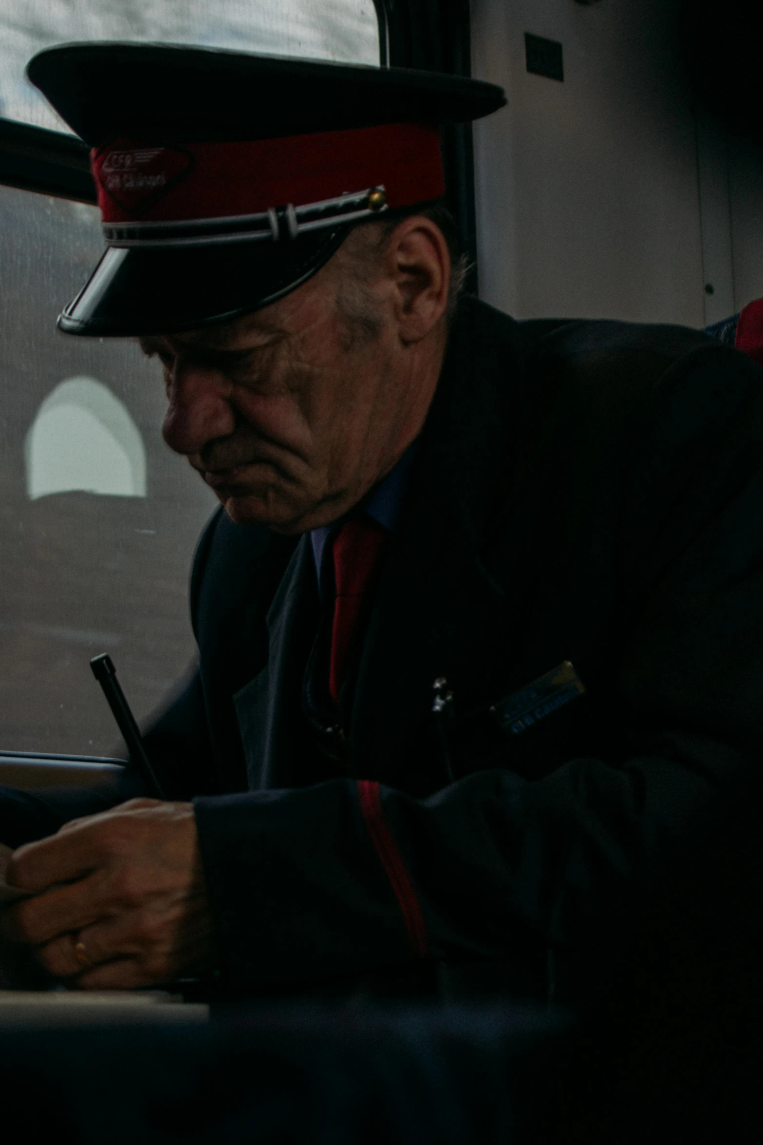 a man in uniform writing on a piece of paper, by Jörg Immendorff, pexels contest winner, polar express, 2 0 2 1 cinematic 4 k framegrab, old man doing hard work, instagram story