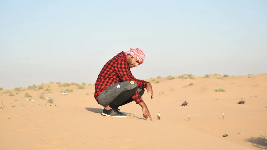 a man that is kneeling down in the sand, in the middle of the desert, profile image, picnic, dukhara scavenger