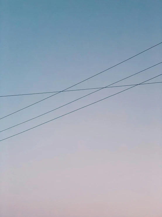 a stop sign sitting on the side of a road, a minimalist painting, by Carey Morris, unsplash, postminimalism, cable electric wires, soft blue and pink tints, 3 layers of sky above each other, during dawn