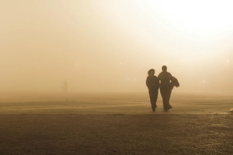 a couple of people that are walking in the fog, pexels contest winner, romanticism, yellow sky, brown, plain, hispanic