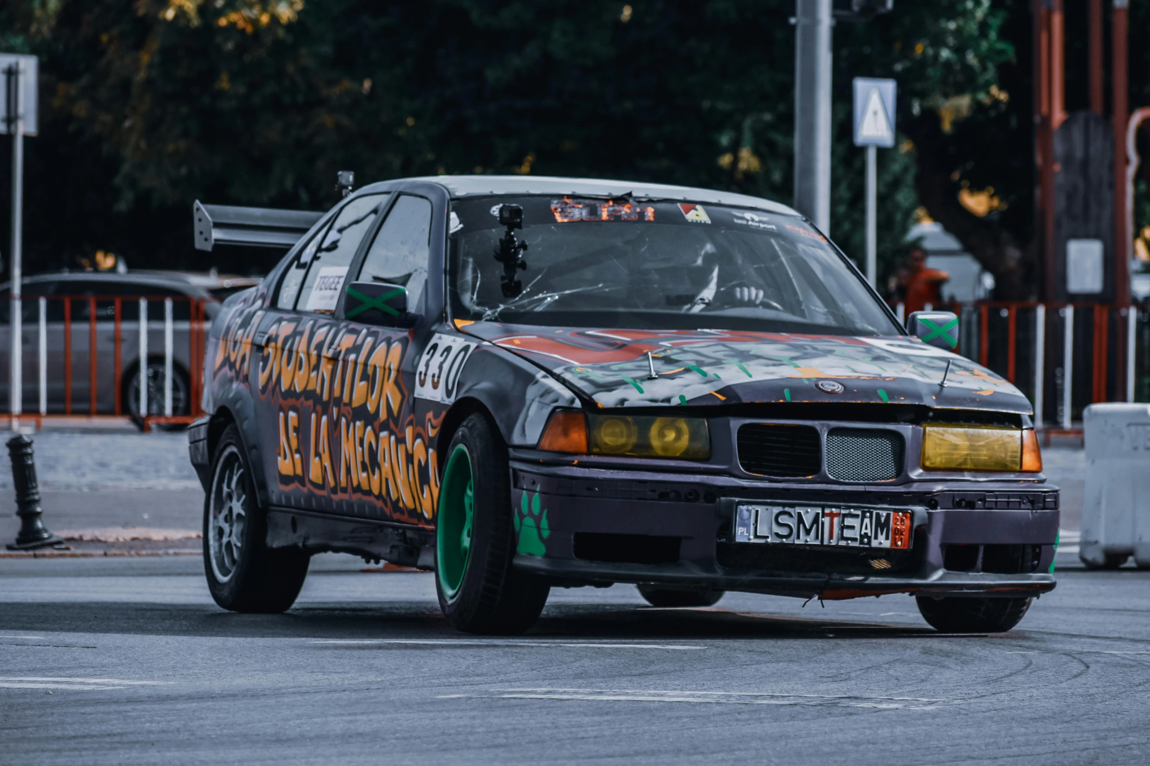 a car with graffiti painted on it driving down a street, by Adam Marczyński, pexels contest winner, on a racetrack, bmw, tournament, cardboard