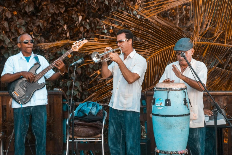 a group of men standing next to each other on a stage, by Sam Dillemans, pexels contest winner, holding maracas, cuban setting, playing drums, al fresco