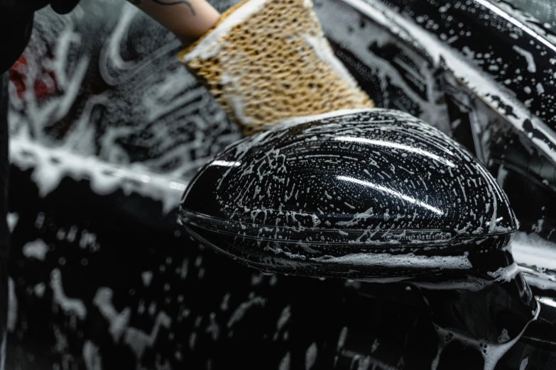 a person washing a car with a sponge, a stipple, by Julia Pishtar, unsplash, made of smooth black goo, holding brush, performance, vantablack