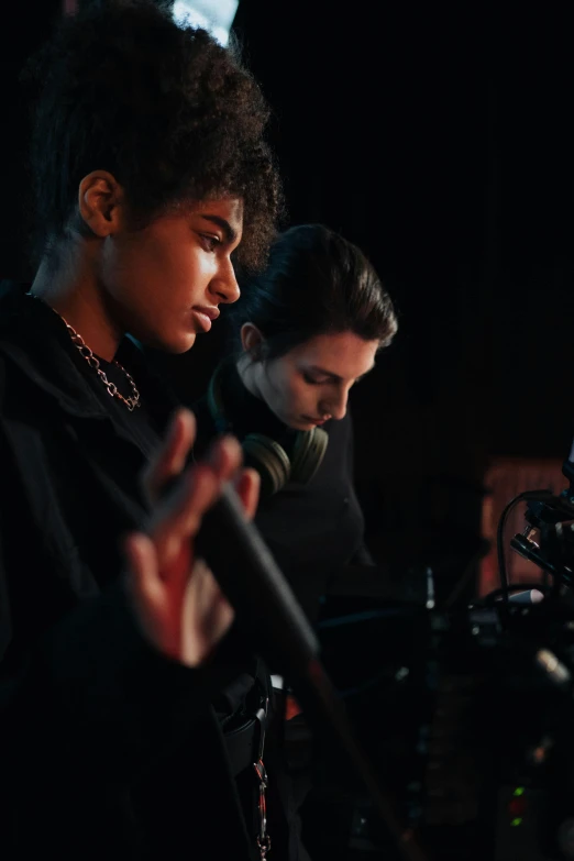 a couple of people that are standing in front of a camera, performing a music video, imaan hammam, studious chiaroscuro, mixing