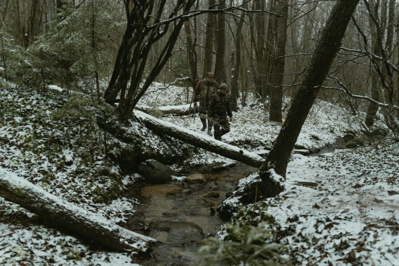 a man walking through a snow covered forest, by Dan Frazier, unsplash, renaissance, camouflage uniform, streams, multicam, 2 5 6 x 2 5 6 pixels