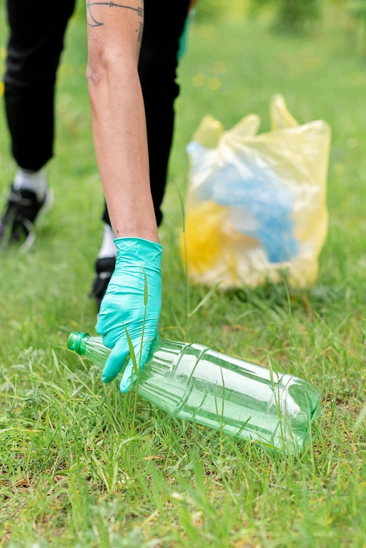 a person picking up a plastic bottle in the grass, 8 l, gloves on hands, cleanest image, pastel'