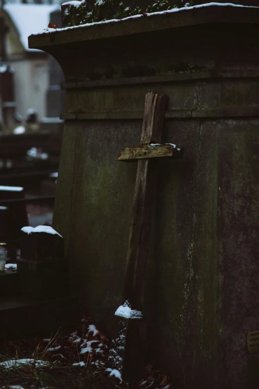 a cemetery filled with lots of tombstones covered in snow, an album cover, by Attila Meszlenyi, unsplash, medieval sword on stone, wooden, dressed in a worn, cross