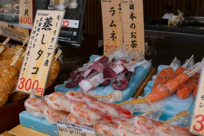 a display case filled with lots of different types of food, a picture, unsplash, sōsaku hanga, prawn, square, harbor, 2000s photo