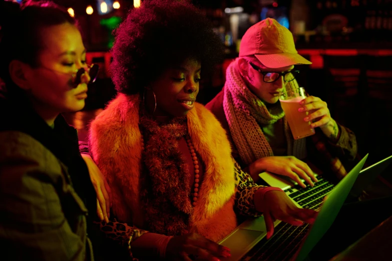 a group of people sitting in front of a laptop computer, a portrait, by Joe Bowler, pexels, funk art, small neon keyboard, sitting at a bar, ashteroth, warm coloured