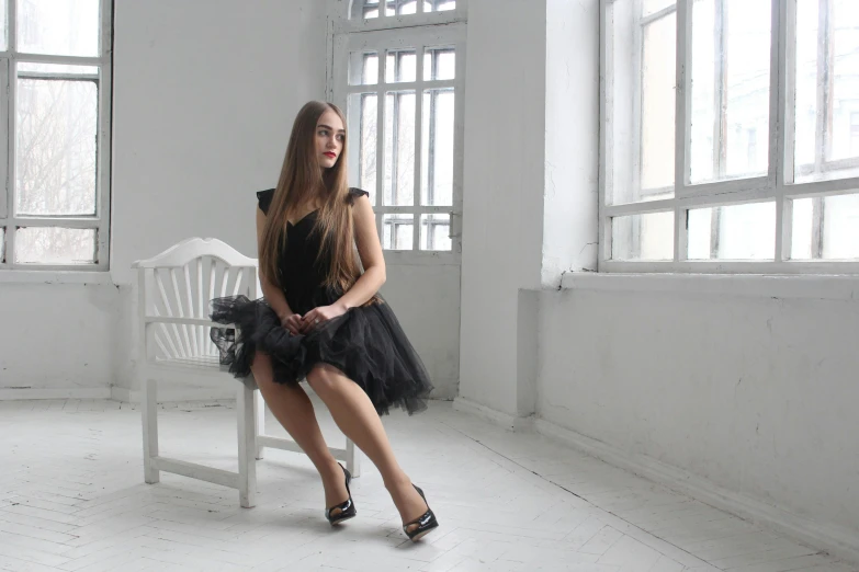 a woman in a black dress sitting on a white bench, wearing a tutu, dasha taran, in white room, profile image