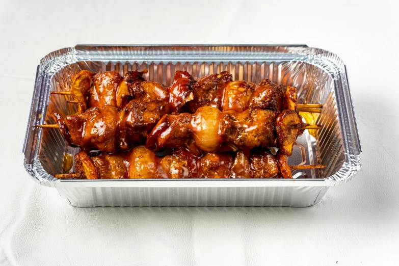 a close up of a tray of food on a table, product image, skewer, front facing shot, stew