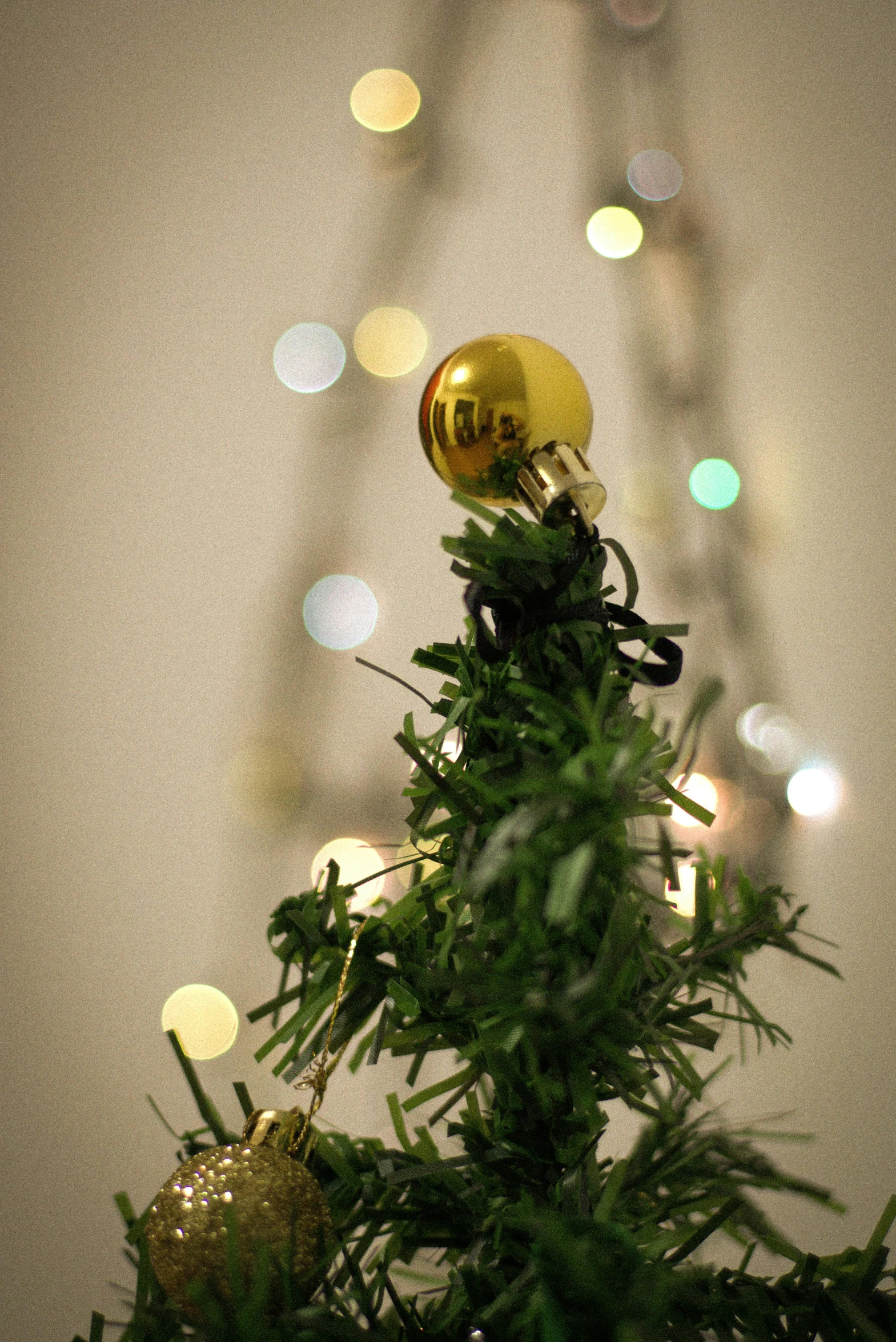 a close up of a christmas tree with lights in the background, topiary, exposed gold wires, experimental, multi-part