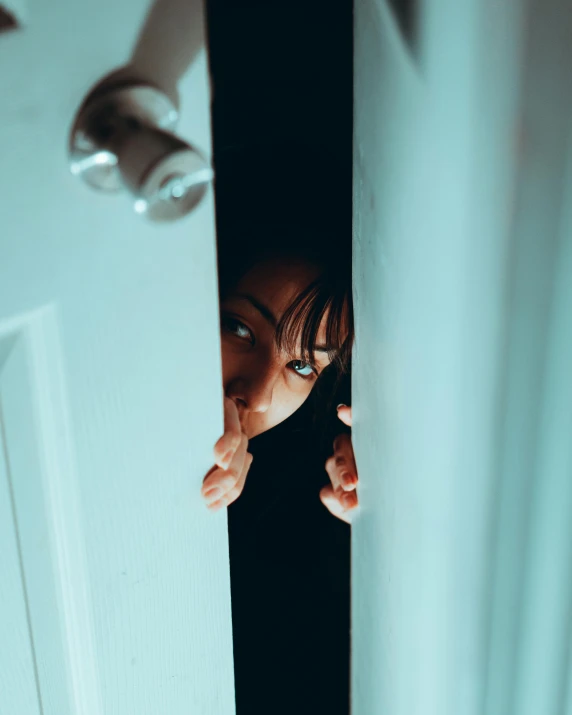 a woman peeking out from behind a door, a stock photo, inspired by Elsa Bleda, pexels contest winner, happening, scary night, lgbtq, looking surprised, the ring movie