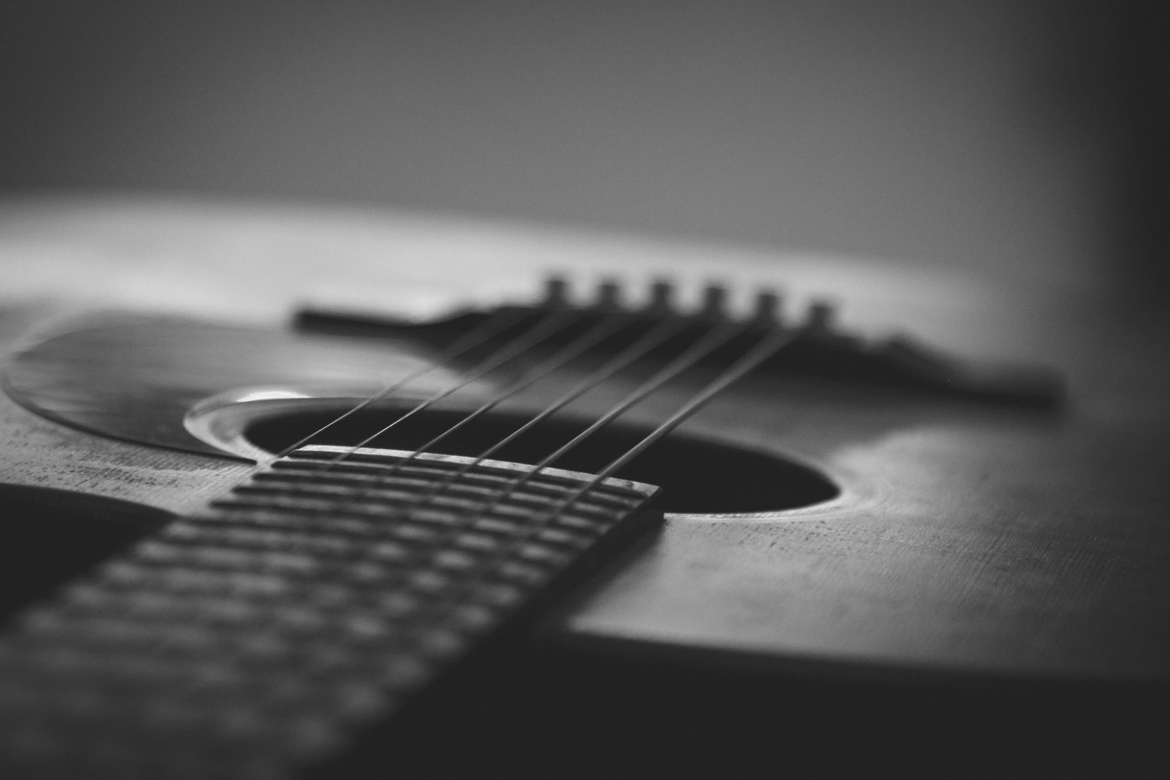 a black and white photo of a guitar, by Kristian Zahrtmann, pexels contest winner, strings, realistic picture, acoustic information, mysterious mood