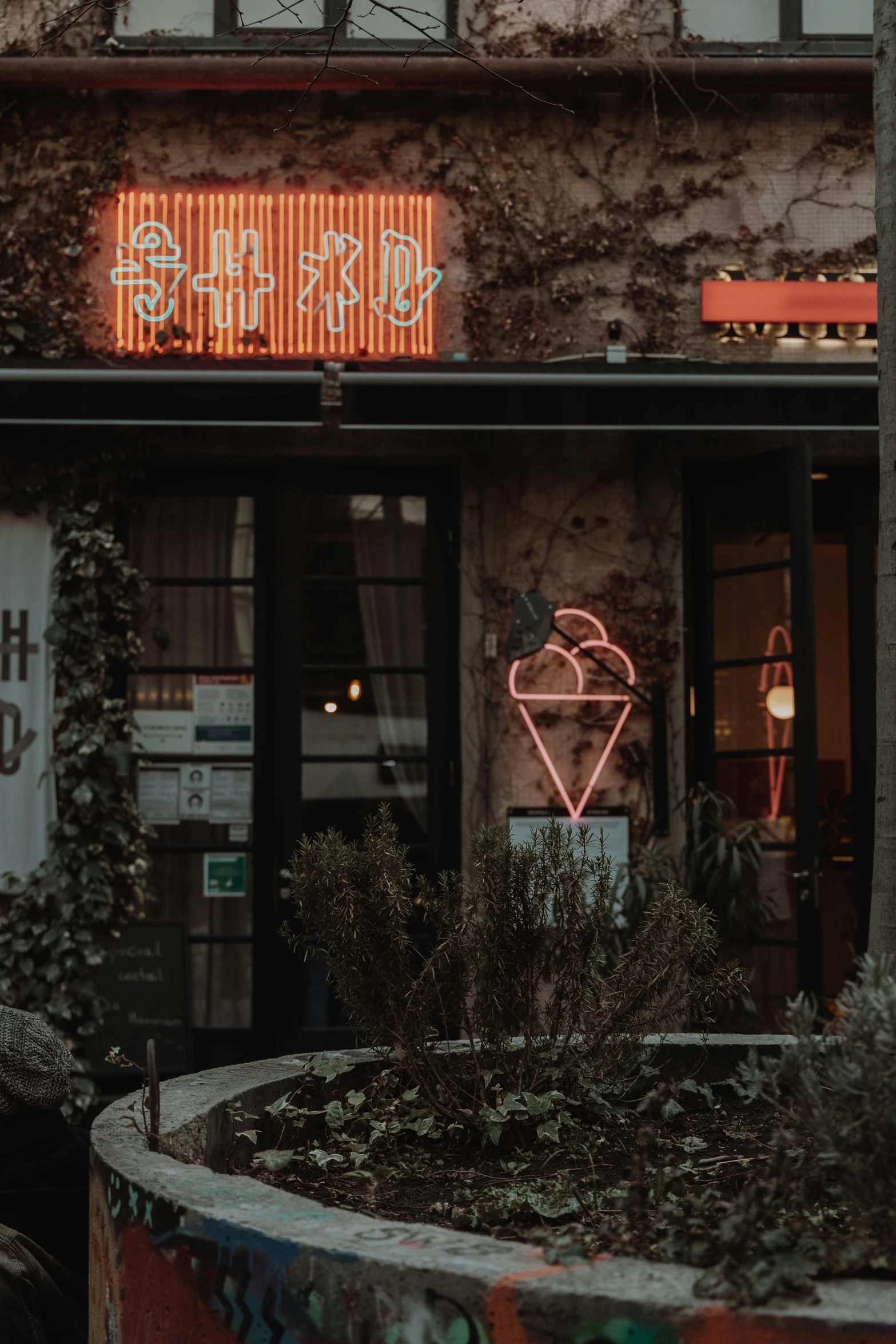 a building with a neon sign in front of it, a photo, trending on unsplash, art nouveau, cozy cafe background, low quality photo, brown and pink color scheme, monochrome