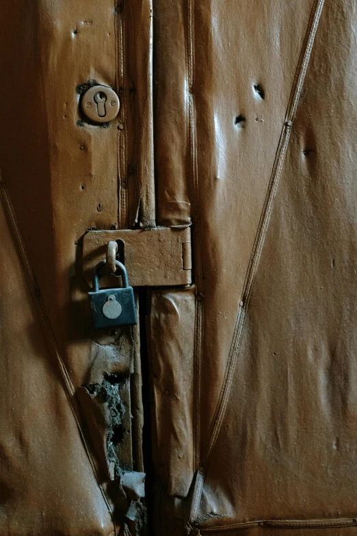 a close up of a door with a padlock, by artist, arte povera, wearing a brown leather coat, taken in the late 2010s, promo image, under repairs