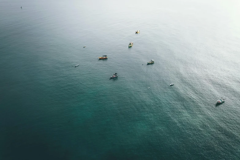 a group of boats floating on top of a body of water, by Adam Marczyński, pexels contest winner, minimalism, ocean sprites, dredged seabed, high quality screenshot, manly