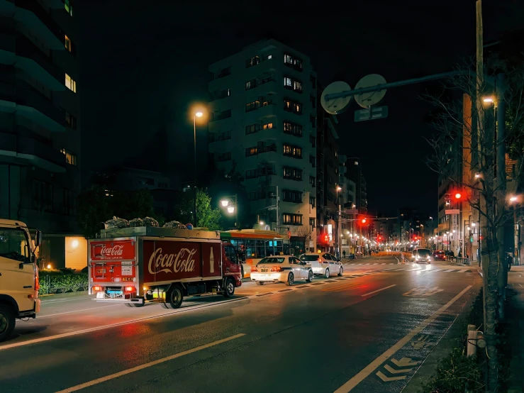 a street filled with lots of traffic next to tall buildings, inspired by Elsa Bleda, unsplash contest winner, sōsaku hanga, a firetruck at night, japanese town, photograph taken in 2 0 2 0, jollibee city