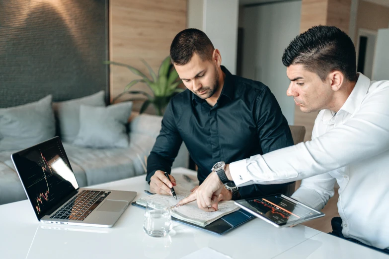 two men sitting at a table working on laptops, pexels contest winner, professional branding, papers on table, lachlan bailey, avatar image