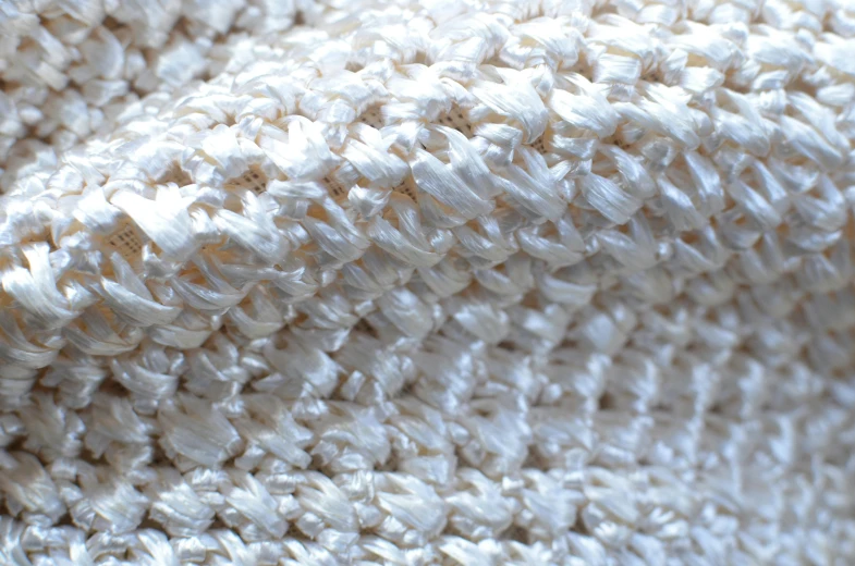 a close up of a white blanket on a bed, by Shigeru Aoki, flickr, woven armour, super highly detailed, vanilla, natural
