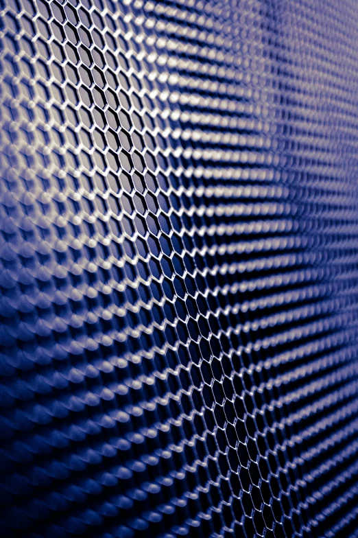 a close up of a piece of metal, an album cover, unsplash, kinetic pointillism, glowing blue interior components, mechanically enhanced honeycomb, vertical wallpaper, dark blue