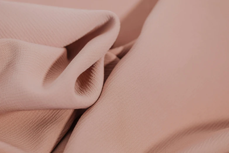 a close up of a piece of cloth, pastel pink robes, silicone skin, product shot, bronze material