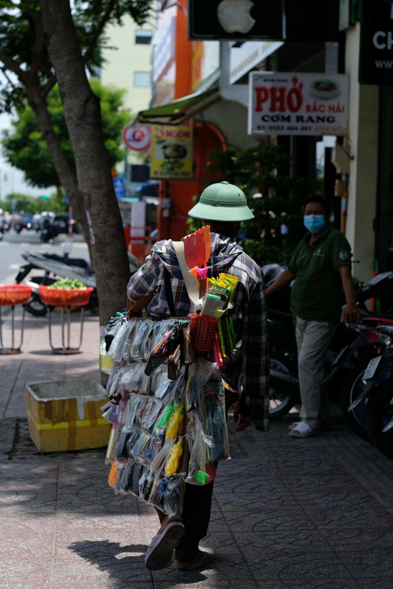 a person that is walking down the street, vietnam, plastic and fabric, square, with a bunch of stuff