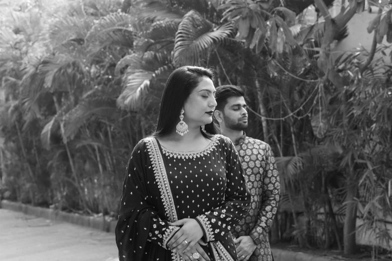 a man and a woman standing next to each other, a black and white photo, pexels, wearing a silk kurta, ✨🕌🌙, 4k greyscale hd photography, trending on devian art