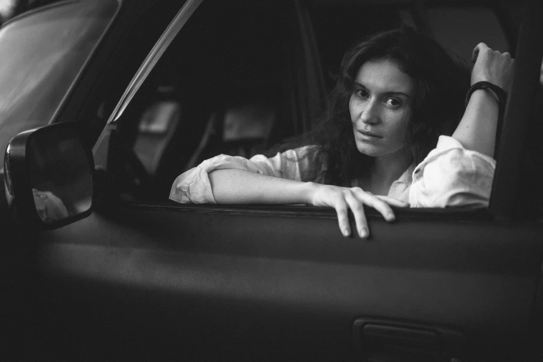 a woman sitting in a car looking out the window, a black and white photo, by Daniel Gelon, renaissance, portrait image, sergey krasovskiy, worried, high quality film still