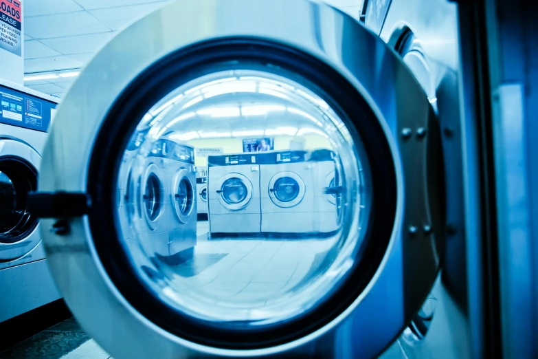 a row of washing machines sitting next to each other, by Konrad Witz, shutterstock, process art, everything enclosed in a circle, commercial photo, stainless steel, looking in front