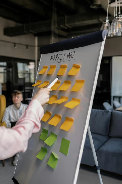 a woman standing in front of a board with sticky notes on it, by Adam Marczyński, pexels contest winner, person in foreground, product advertising, 1 6 x 1 6, magnetic