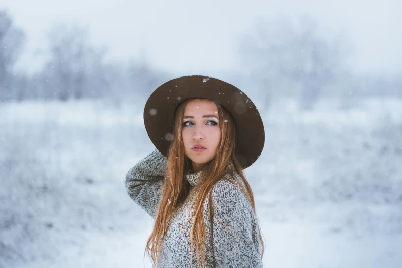 a woman standing in the snow wearing a hat, a portrait, pexels contest winner, girl with brown hair, avatar image, ad image, teen girl