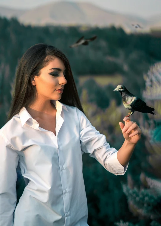 a woman in a white shirt is holding a bird, by Julia Pishtar, pexels contest winner, handsome girl, holding nevermore, islamic, avatar image