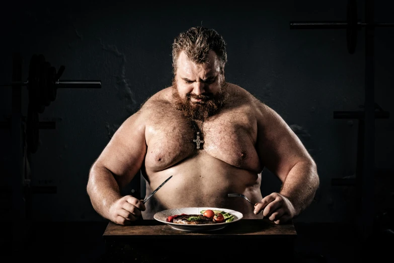 a man sitting at a table with a plate of food, an album cover, by Daniel Seghers, pexels contest winner, renaissance, massive muscles, wojtek fus, big belly, bearded and built