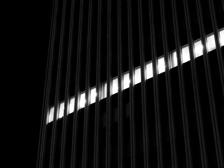 a black and white photo of a tall building, inspired by Ryoji Ikeda, unsplash, postminimalism, window lighting, dan flavin, behind bars, black background pinterest