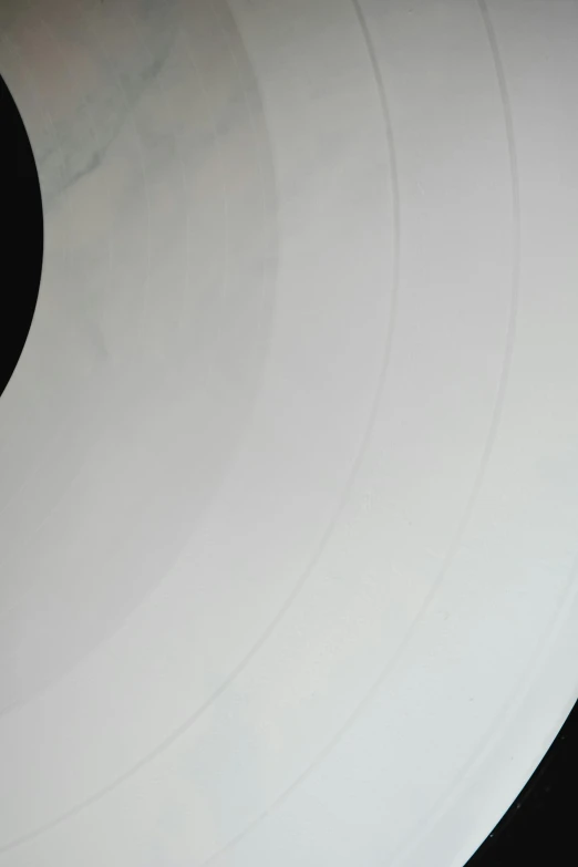 a white vinyl record sitting on top of a table, by Doug Ohlson, plasticien, taken through a telescope, very detailed curve, large)}], stacked image