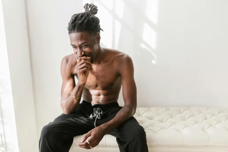 a man sitting on a couch smoking a cigarette, inspired by Charles Martin, trending on pexels, visual art, playboi carti portrait, physical : tinyest midriff ever, panel of black, on a pale background