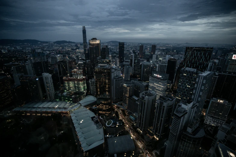 an aerial view of a city at night, by Patrick Ching, pexels contest winner, hyperrealism, overcast dusk, ominous background, shenzhen, ominous evening