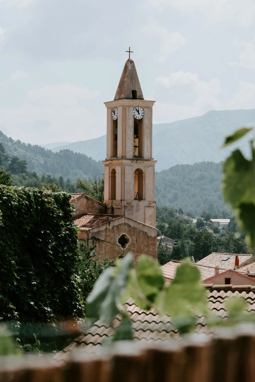 a clock tower sitting in the middle of a town, a picture, by Raphaël Collin, pexels contest winner, romanesque, overlooking a valley with trees, traditional corsican, 2 5 6 x 2 5 6 pixels, church in the wood