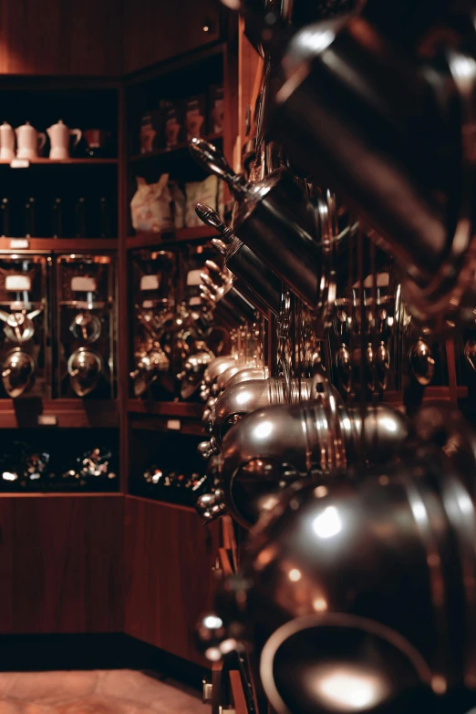 a kitchen filled with lots of pots and pans, by Frederik Vermehren, unsplash, kinetic art, in a pub, exquisite details, shiny knobs, cellar