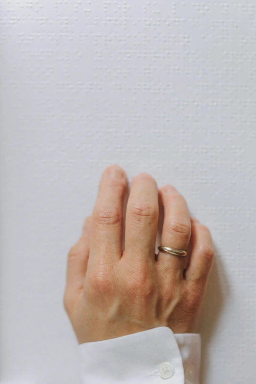 a close up of a person with a ring on their finger, a photorealistic painting, by artist, unsplash, white wall, rinko kawaichi, very thin, silver，ivory