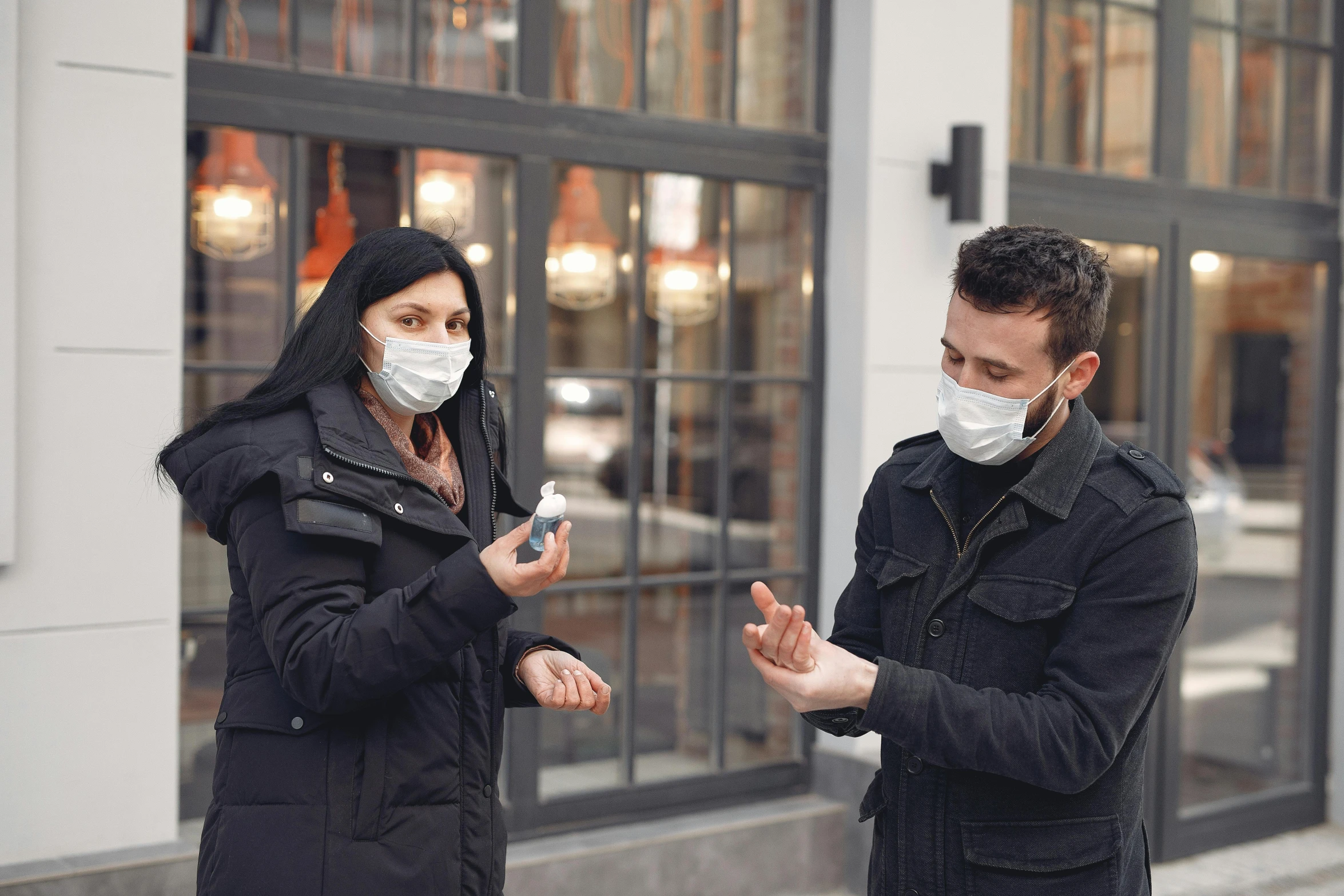 a man and a woman wearing face masks, by Emma Andijewska, pexels, happening, holding a small vape, 5 feet away, avatar image, gloves on hands