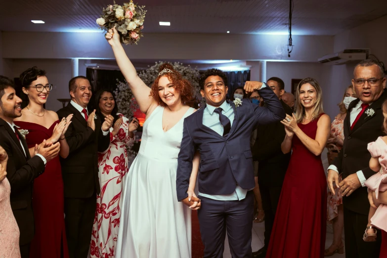 a man and a woman standing in front of a crowd of people, floating bouquets, standing triumphant and proud, wedding photography, mix of ethnicities and genders