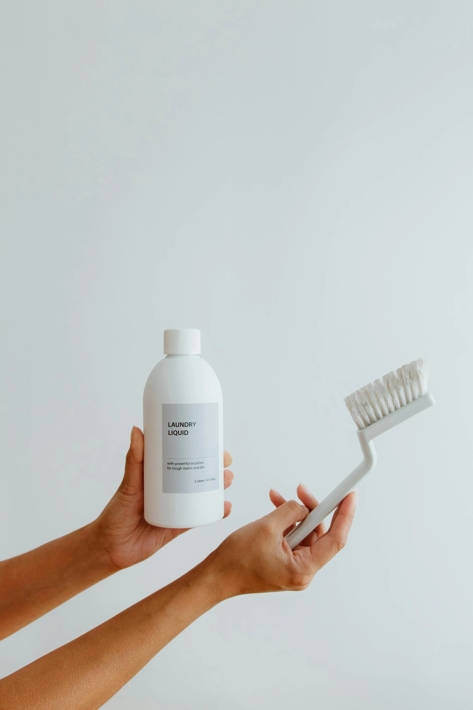 a person holding a toothbrush and a bottle of toothpaste, light grey mist, with long hair, clean detail, utilitarian