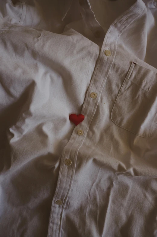 a white shirt with a red heart on it, an album cover, unsplash, rinko kawauchi, buttons, ignant, worn clothes