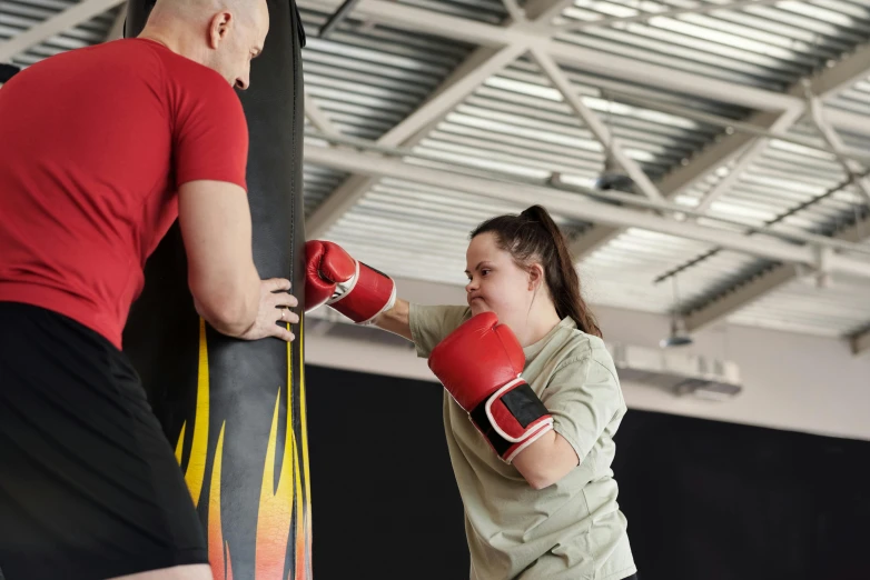 a man and a woman boxing in a gym, by Emma Andijewska, hurufiyya, still photograph, small, profile image