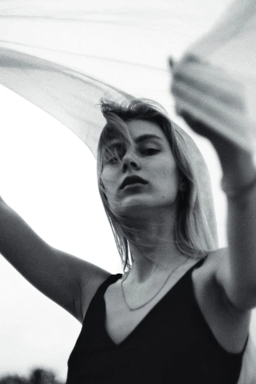 a black and white photo of a woman with a veil, a black and white photo, unsplash, the wind moves her shirt, a blond, eva elfie, photographed on colour film