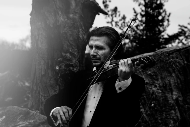 a man in a tuxedo playing a violin, a black and white photo, unsplash, viktor orban in a forest, avatar image, wedding, profile picture