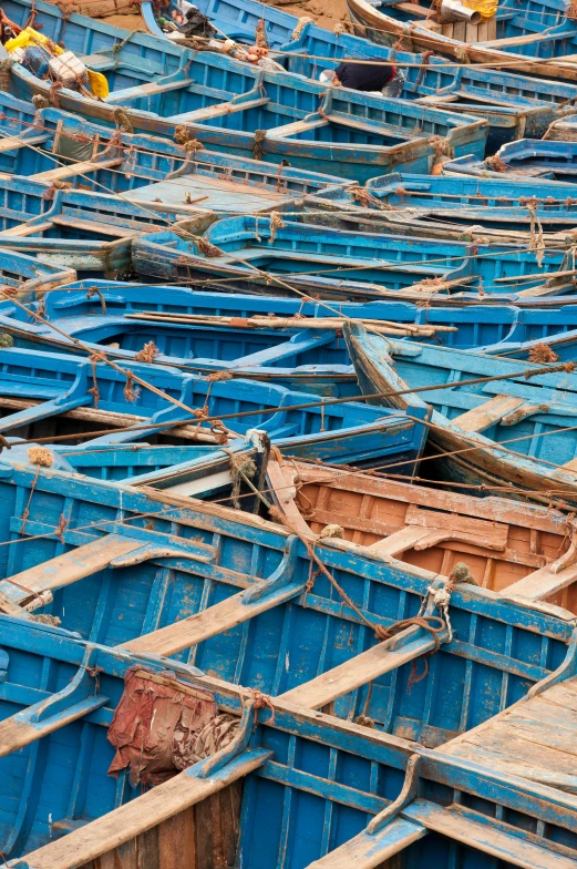 a bunch of blue boats sitting on top of a beach, slide show, marrakech, close - up photograph, photograph