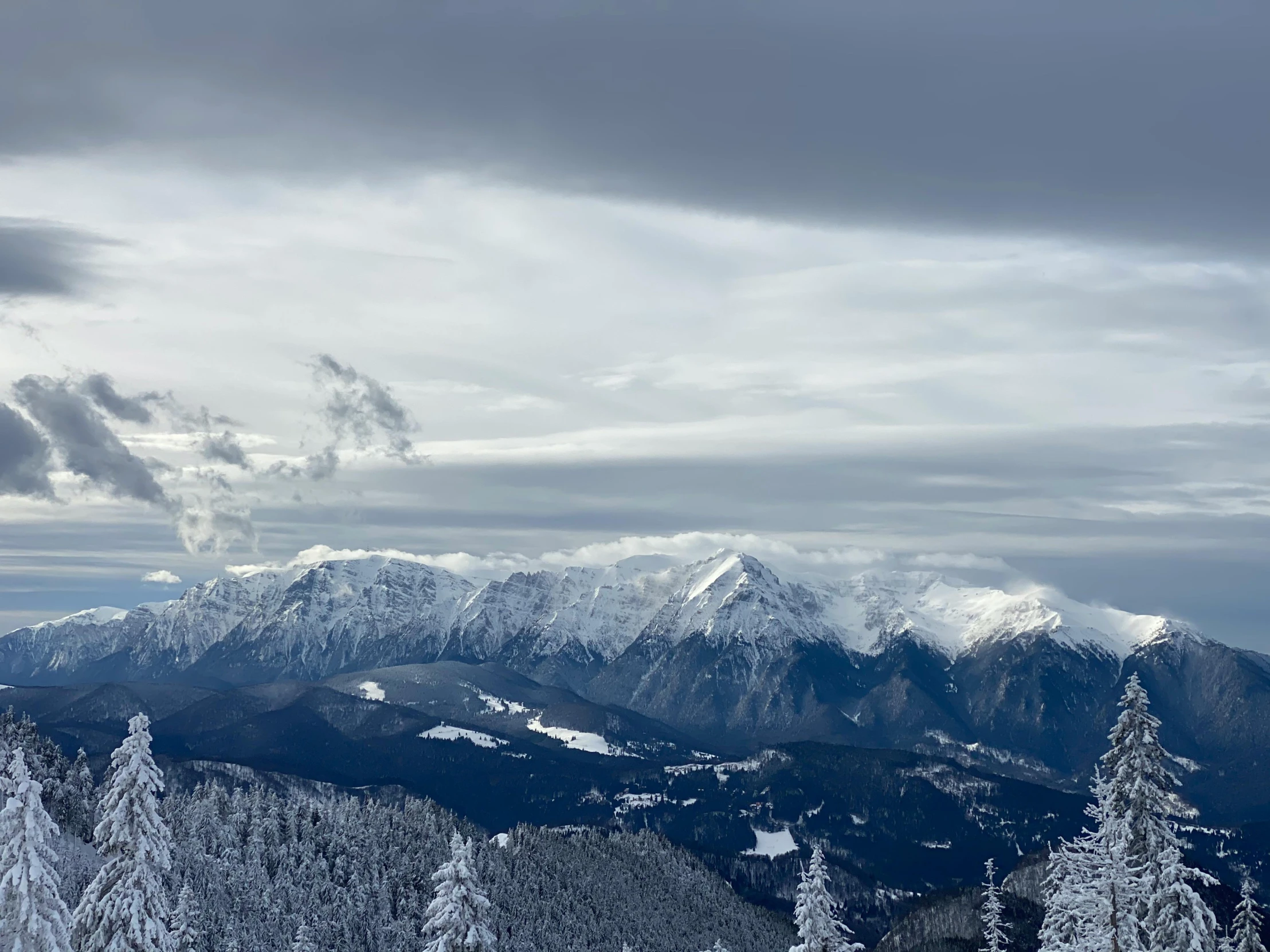 a man riding skis on top of a snow covered slope, by Jozef Simmler, pexels contest winner, baroque, overlooking a valley with trees, brooding clouds', (3 are winter, mount olympus